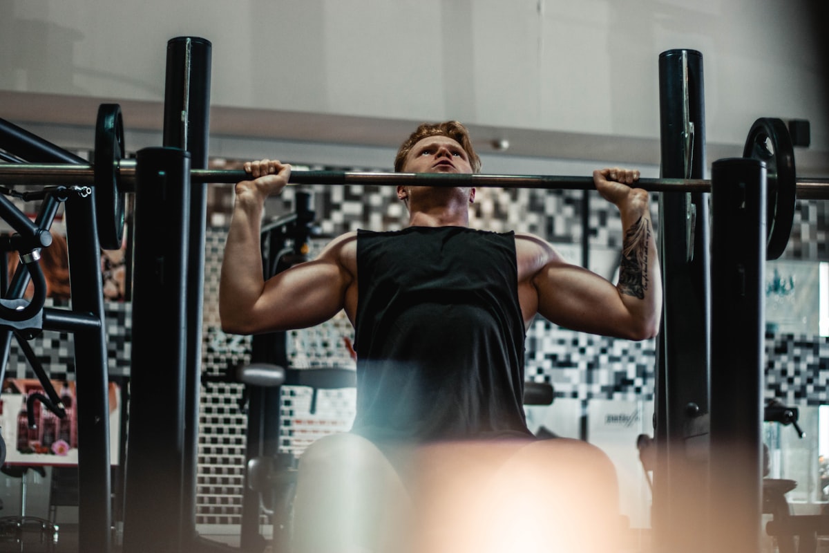 Athlete's chalked hands gripping a barbell
